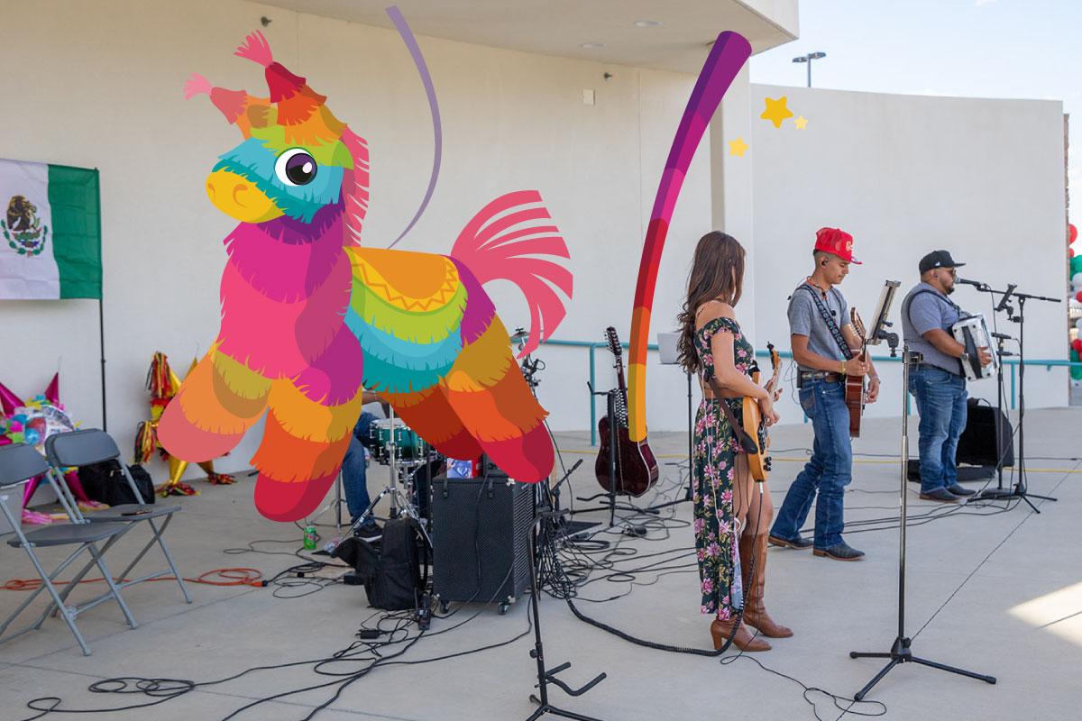 A band playing on the SJC Graduation Plaza stage with a colorful pinata to the right